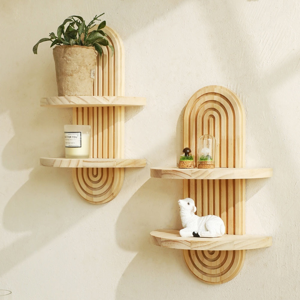 Wooden wall shelves with decorative items on a light beige wall