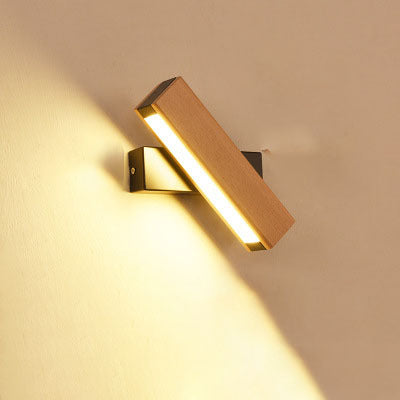 Modern wall-mounted light fixture on a beige wall